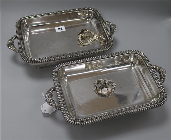 A pair of plated entree dishes, covers and stands